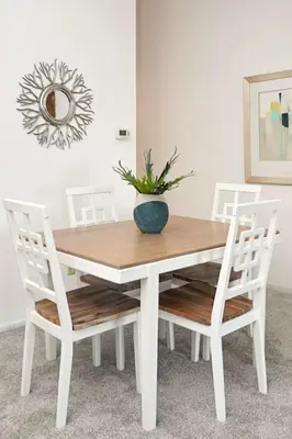 a white dining room table and chairs with a plant on it at Adorable MtAdams 2BR near it all in Cincinnati
