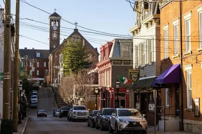 a city street with a clock tower and cars parked at Adorable MtAdams 2BR near it all in Cincinnati