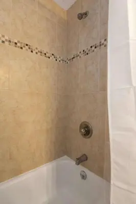 a bathroom with a shower with a bath tub at Adorable MtAdams 2BR near it all in Cincinnati