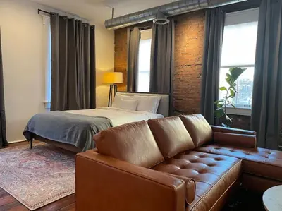 a living room with a couch and a bed at Loft in the heart of Over-The-Rhine in Cincinnati