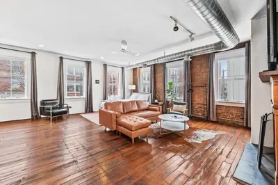 a living room with a couch and a table at Loft in the heart of Over-The-Rhine in Cincinnati