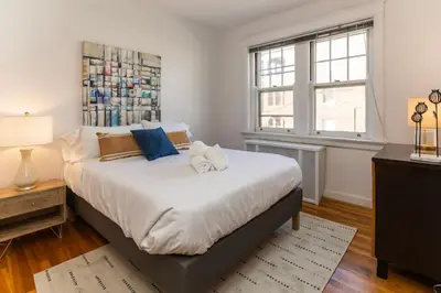 a bedroom with a large bed and a window at Hyde Park Comfort with Office Near Everything in Cincinnati