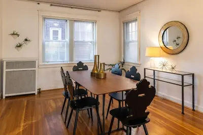 a dining room with a table and chairs and a mirror at Hyde Park Comfort with Office Near Everything in Cincinnati
