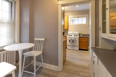 a kitchen with a white table and a white stove at Hyde Park Comfort with Office Near Everything in Cincinnati