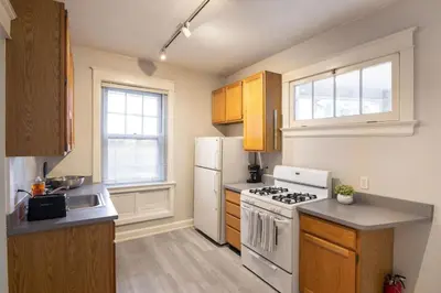 a kitchen with a stove and a white refrigerator at Hyde Park Comfort with Office Near Everything in Cincinnati