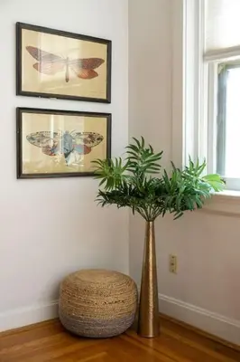 a gold vase with a plant in a room at Hyde Park Comfort with Office Near Everything in Cincinnati