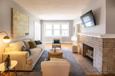 a living room with a couch and a fireplace at Hyde Park Comfort Near Rookwood in Cincinnati