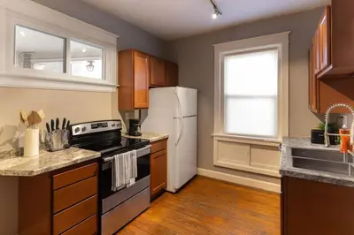 a kitchen with a stove and a refrigerator at Hyde Park Comfort Near Rookwood in Cincinnati