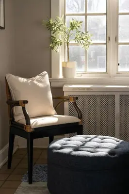 a chair and a ottoman in a room with a window at Hyde Park Comfort Near Rookwood in Cincinnati