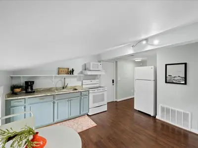 a kitchen with blue cabinets and a white refrigerator at Studio steps to Soccer and OTR and Downtown in Cincinnati