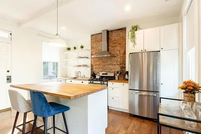 a kitchen with white cabinets and a stainless steel refrigerator at Walk to Rhinegeist, Findlay Market, FREE Streetcar in Cincinnati