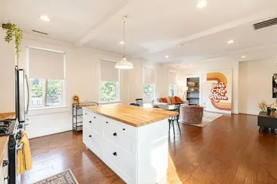 a kitchen with a white island with a wooden counter top at Walk to Rhinegeist, Findlay Market, FREE Streetcar in Cincinnati