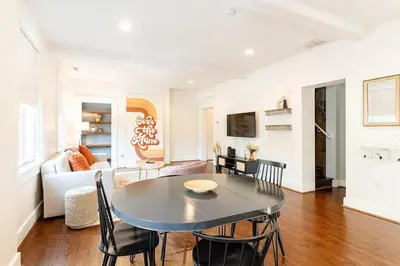 a dining room and living room with a table and chairs at Walk to Rhinegeist, Findlay Market, FREE Streetcar in Cincinnati