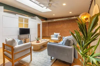a living room with a couch and chairs and a tv at Spacious Retreat w Private Roof Deck Walkable to ALL in Cincinnati