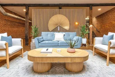 a living room with a blue couch and a coffee table at Spacious Retreat w Private Roof Deck Walkable to ALL in Cincinnati