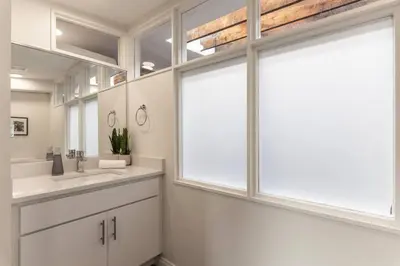 a bathroom with a sink and a large window at Spacious Retreat w Private Roof Deck Walkable to ALL in Cincinnati