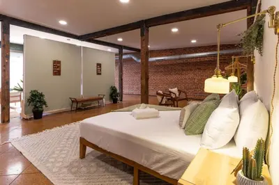 a large room with a bed and a couch at Spacious Retreat w Private Roof Deck Walkable to ALL in Cincinnati