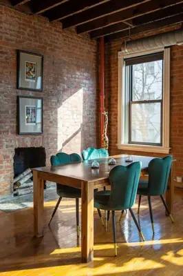 a dining room with a wooden table and chairs at Spacious Retreat w Private Roof Deck Walkable to ALL in Cincinnati