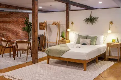 a bedroom with a bed and a table and chairs at Deluxe 3BR Loft Walkable to Everything Downtown in Cincinnati