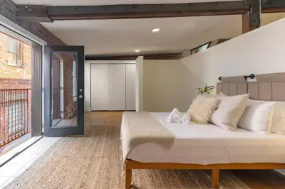 a bedroom with a large bed with white pillows at Deluxe 3BR Loft Walkable to Everything Downtown in Cincinnati