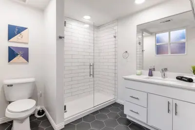 a white bathroom with a toilet and a sink at Deluxe 3BR Loft Walkable to Everything Downtown in Cincinnati