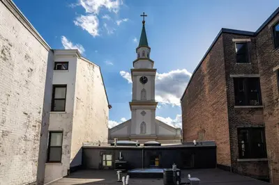a church steeple with a clock tower in the background at Deluxe 3BR Loft Walkable to Everything Downtown in Cincinnati