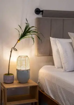 a bedroom with a bed with a plant on a table at Deluxe 3BR Loft Walkable to Everything Downtown in Cincinnati