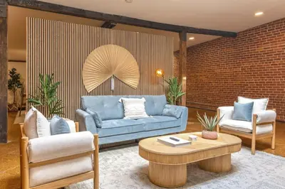 a living room with a blue couch and two chairs at Deluxe 3BR Loft Walkable to Everything Downtown in Cincinnati