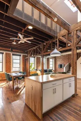an open kitchen and dining room with a loft at Stunning Loft in the heart of OTR in Cincinnati