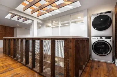 a laundry room with two washer and dryer machines at Stunning Loft in the heart of OTR in Cincinnati