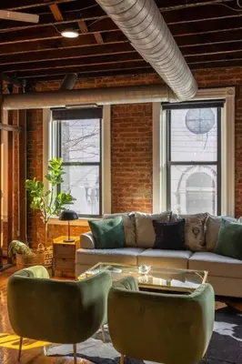 a living room with a couch and two chairs at Stunning Loft in the heart of OTR in Cincinnati