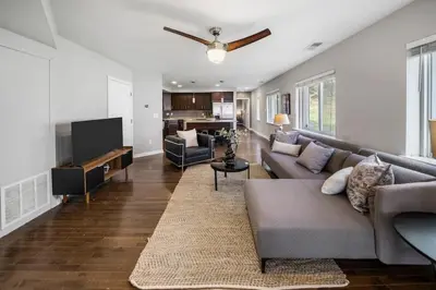 a living room with a couch and a flat screen tv at Comfortable 2BR Condo near City Center in Cincinnati