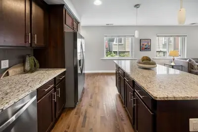 a kitchen with wooden cabinets and a counter top at Comfortable 2BR Condo near City Center in Cincinnati