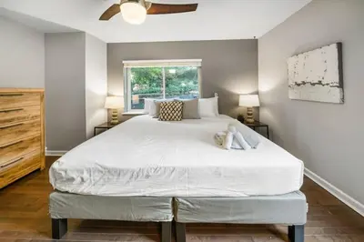 a bedroom with a large bed and a window at Comfortable 2BR Condo near City Center in Cincinnati