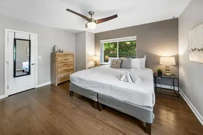 a bedroom with a large bed and a window at Comfortable 2BR Condo near City Center in Cincinnati