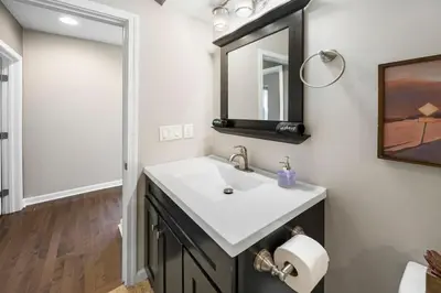 a bathroom with a sink and a mirror at Comfortable 2BR Condo near City Center in Cincinnati