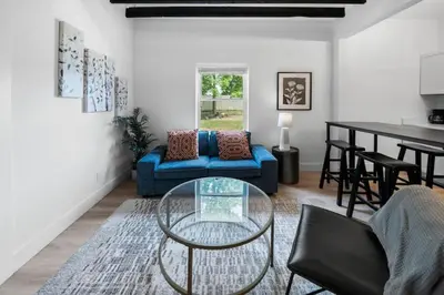 a living room with a blue couch and a table at Spacious and Modern 3BR near Downtown and Walnut Hills in Cincinnati