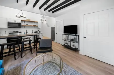 a kitchen and living room with a table and chairs at Spacious and Modern 3BR near Downtown and Walnut Hills in Cincinnati