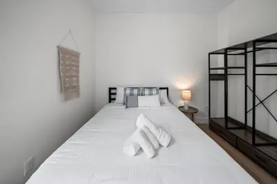 a bedroom with a white bed with towels on it at Spacious and Modern 3BR near Downtown and Walnut Hills in Cincinnati