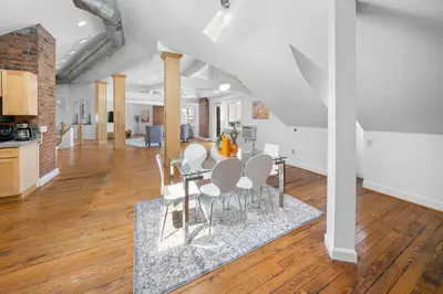 a kitchen and living room with a table and chairs at Hyde Park Penthouse with Private Patio in Cincinnati
