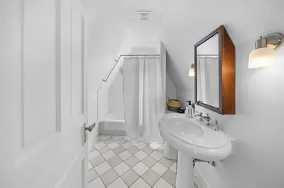 a white bathroom with a sink and a mirror at Hyde Park Penthouse with Private Patio in Cincinnati