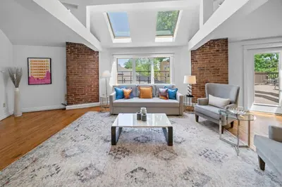 a living room with a couch and a table at Hyde Park Penthouse with Private Patio in Cincinnati