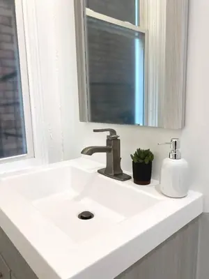 a bathroom sink with a faucet and a mirror at Explore Downtown from Adorable Mount Adams in Cincinnati