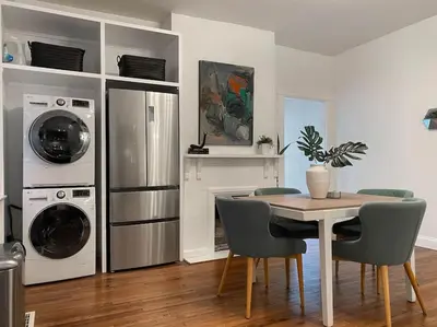 a kitchen with a table with chairs and washing machines at Explore Downtown from Adorable Mount Adams in Cincinnati