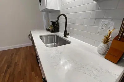 a kitchen with a sink and a white counter top at Explore Downtown from Adorable Mount Adams in Cincinnati