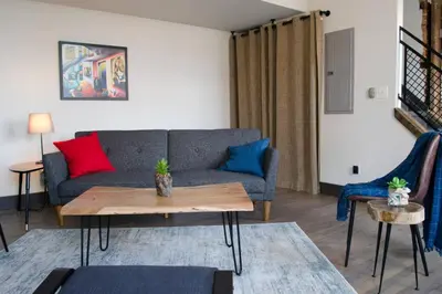 a living room with a couch and a table at Gorgeous Condo in the Heart of OTR Free Parking in Cincinnati