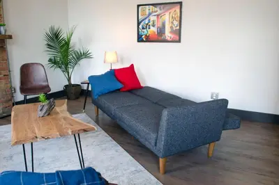 a living room with a couch and a table at Gorgeous Condo in the Heart of OTR Free Parking in Cincinnati