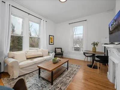 a living room with a white couch and a table at Cozy 1BR Near Zoo, UC, OTR, Downtown in Cincinnati