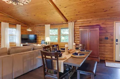 a living room with a table and a couch at Cozy Brookville Home with Fire Pit and Deck! in Brookville