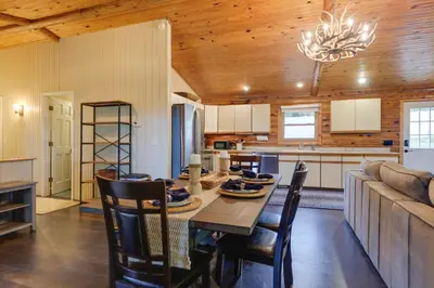a kitchen and dining room with a table and a couch at Cozy Brookville Home with Fire Pit and Deck! in Brookville